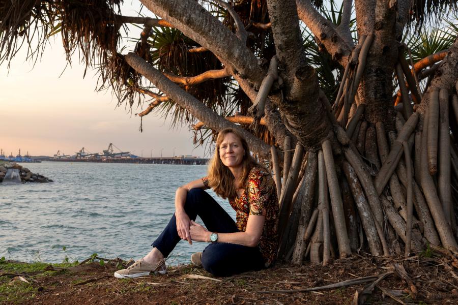 Image of Dr Cal Devney sitting at the base of a tree