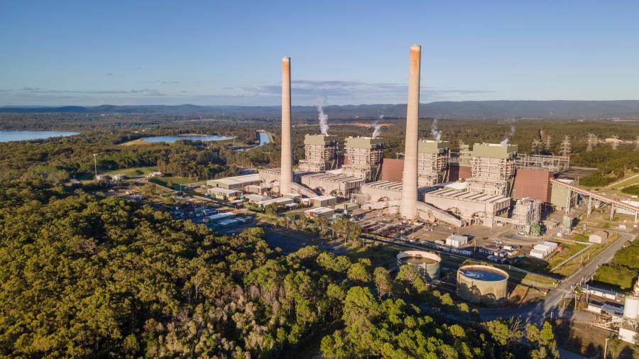 Arial shot of power station - two coal stacks surrounded by bushland