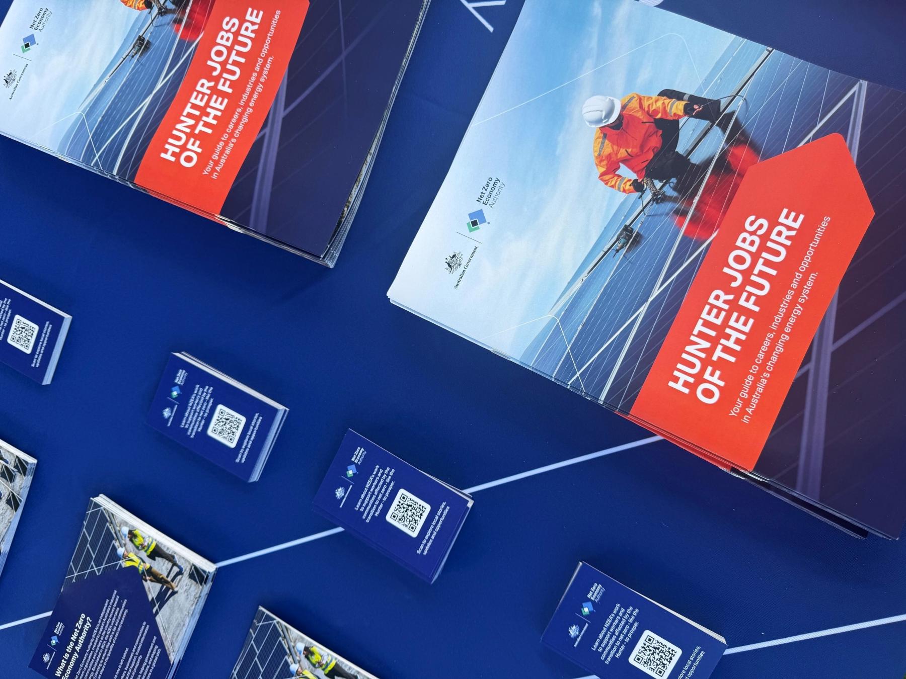 A variety of NZEA brochures and QR code cards