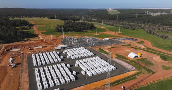 Aerial shot of battery storage facility surrounded by green fields and trees