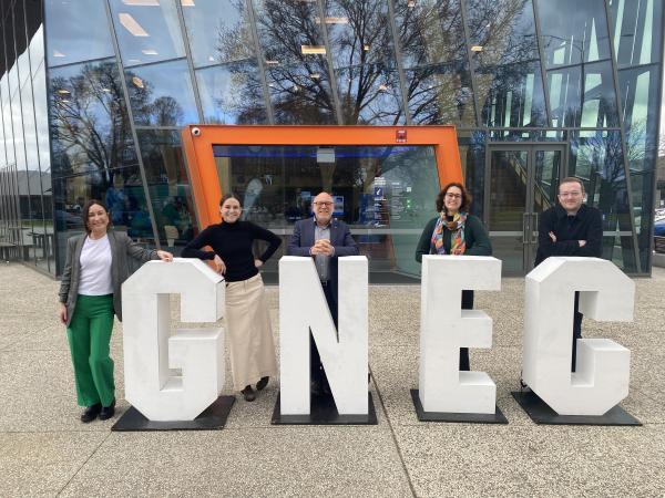 Five NZEA staff with display letters spelling 'GNEC'