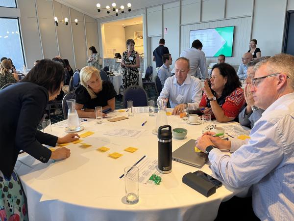 People gathered around a table, deep in conversation and collaboration
