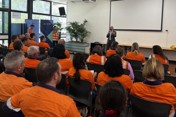 NZEA CEO David Shankey speaking with workers in high-vis gear