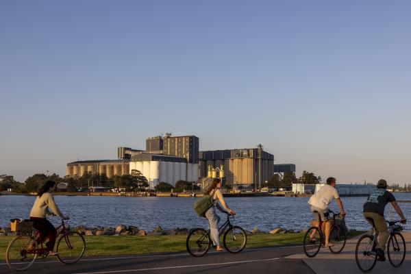 Cyclists on boardwalk in Port of Newcastle